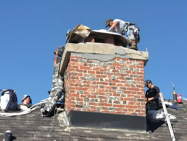 Whitman Chimney Sweep installing a custom chimney crown in Whitman, MA