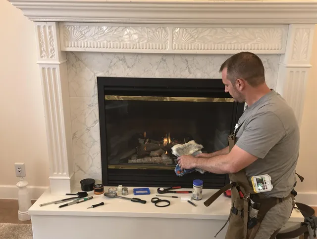 Whitman Chimney Sweep performing fireplace maintenance in Whitman, MA