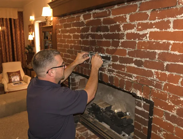 Whitman Chimney Sweep expert fixing a fireplace in Whitman, MA